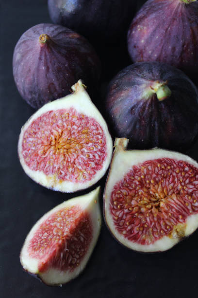 istock Fresh Fig slices purple on a dark background 1272817073