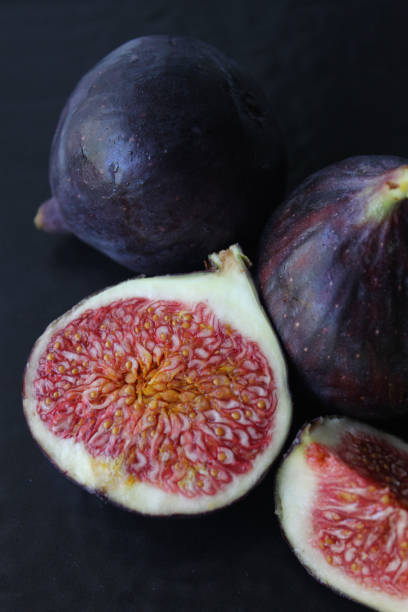 istock Juicy Fig slices on a dark background.Texture or background 1272817161