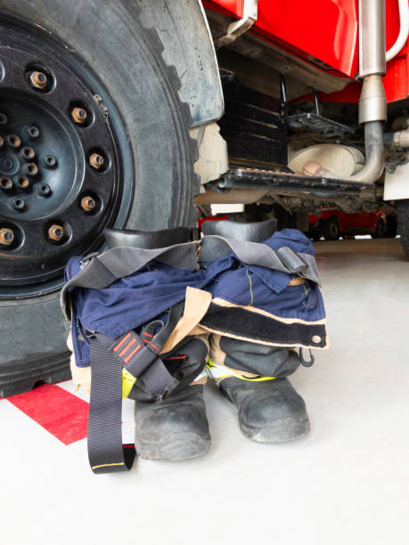 istock Boots and trousers for firefighters located next to a truck. 1272817205