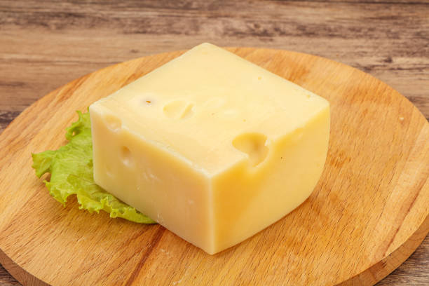 istock Emmental cheese over wooden board 1272818464