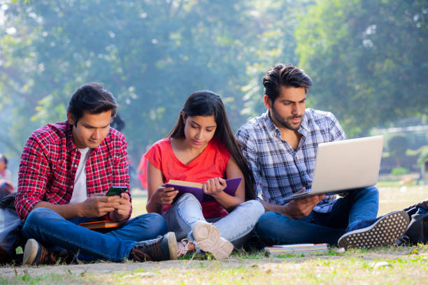 istock Group of students studying in a park stock photo 1272818915