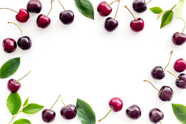 istock Frame of red cherries, berries background. Overhead view 1272818927