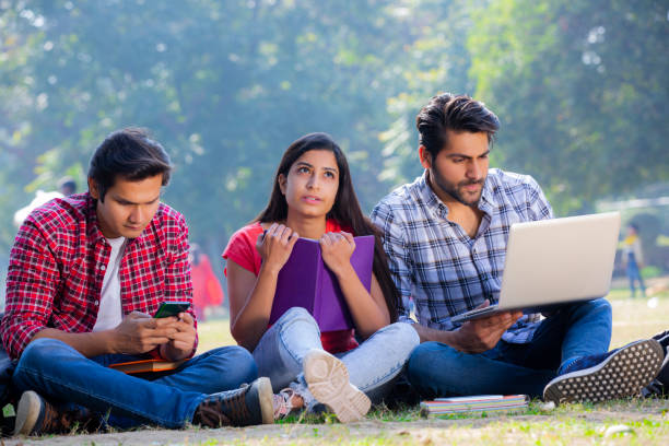 istock Group of students studying in a park stock photo 1272818961