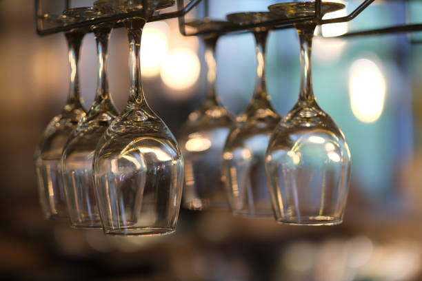 istock close up row of drinking glasses hanging upside down in bar. 1272818978
