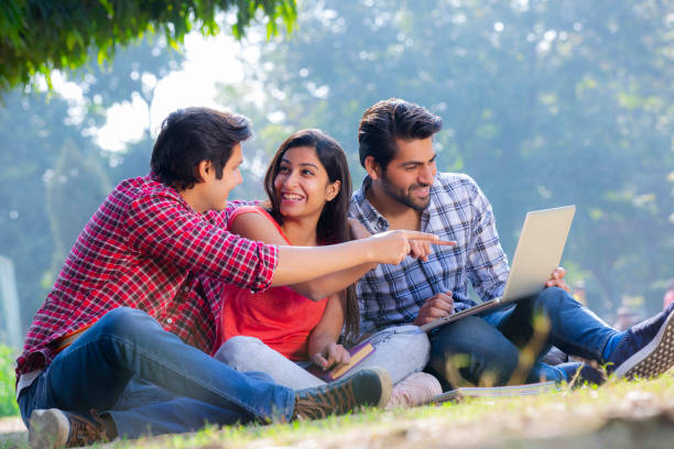istock Group of students studying in a park stock photo 1272820355
