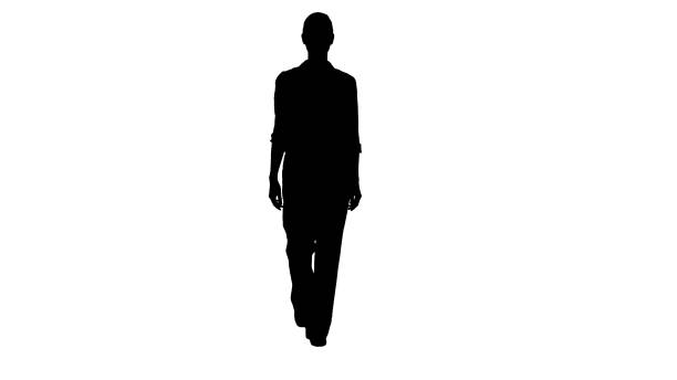 istock Silhouette Glamour business woman walking with hands in her pock 1272820393