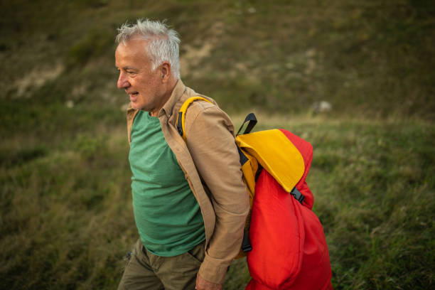 istock Senior man hiking in nature alone 1272820837