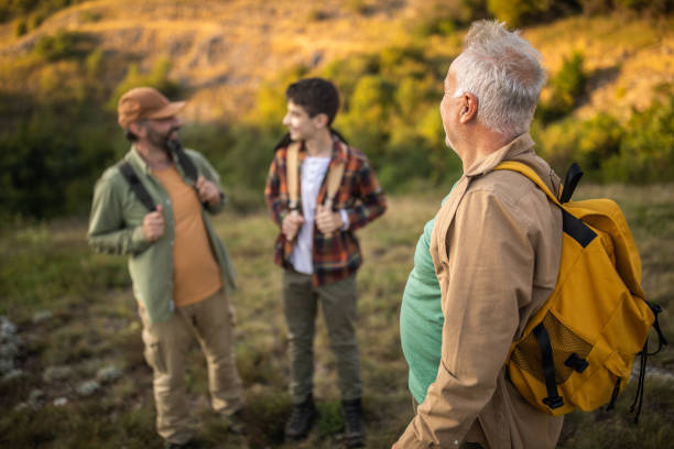 istock Multi-generation family exploring nature together during hiking on mountain 1272821846