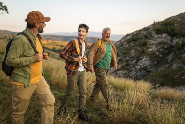 istock Multi-generation family exploring nature together during hiking on mountain 1272821951