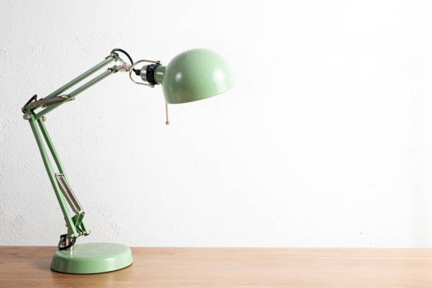istock Green lamp on a wooden desktop table 1272823982