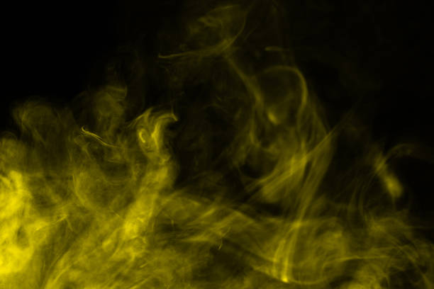 istock Yellow steam on a black background. 1272826750