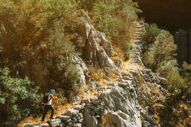 istock Man walking on ancient footpath road in mountain pavement 1272826897