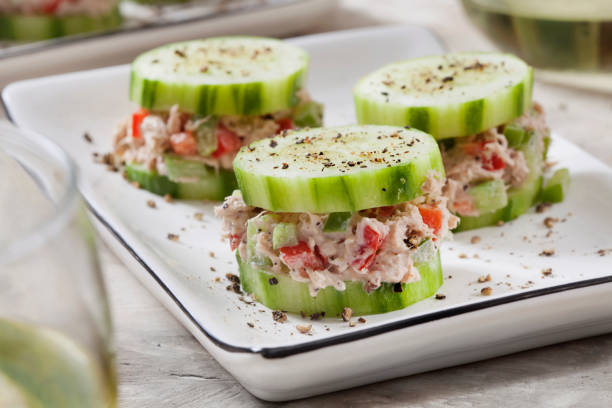 Cucumber Canape with Creamy Tuna Salad Cucumber Canape with Creamy Tuna Salad and Fresh Cracked Pepper seafood salad stock pictures, royalty-free photos & images