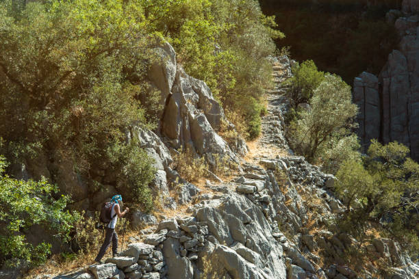 istock Man walking on ancient footpath road in mountain pavement 1272829652