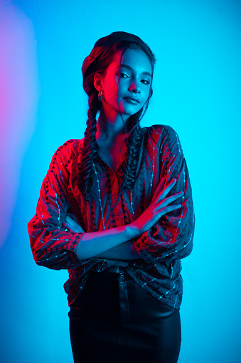 Fashion model Girl in Neon Lights. Beautiful studio photo in colorful bright lights. Cyberpunk, Synthwave, Retrowave Art photo.