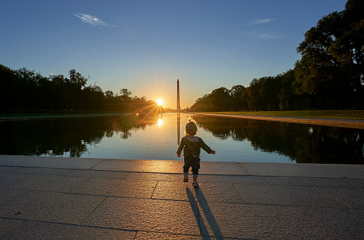 Framed and reflecting Washington Monument.