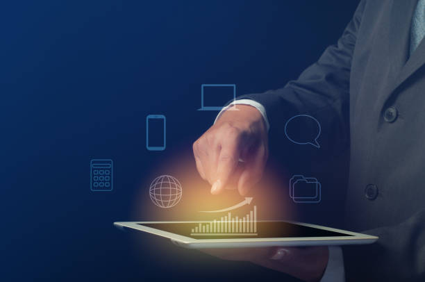 istock businessman use tablet computer with bar graph and digital symbol 1272833989