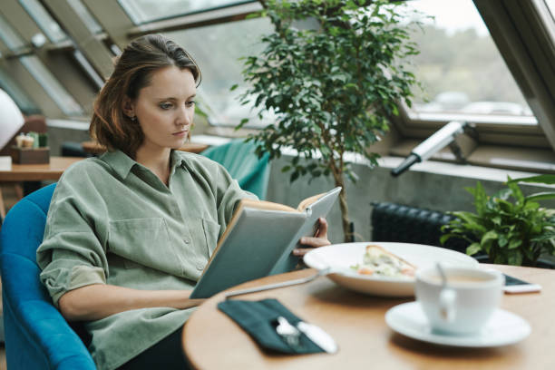 istock Pensive young bearded SMM manager drinking coffee and thinking about customers message while working remotely in cafe 1272834141