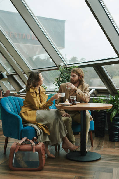 istock Pensive young bearded SMM manager drinking coffee and thinking about customers message while working remotely in cafe 1272835437