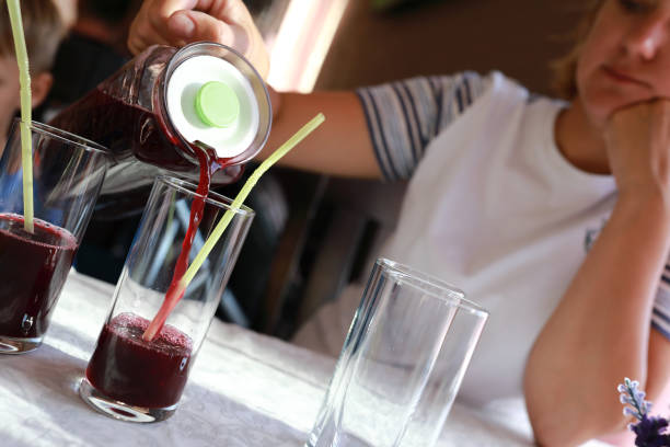 istock Woman pouring juice 1272837151