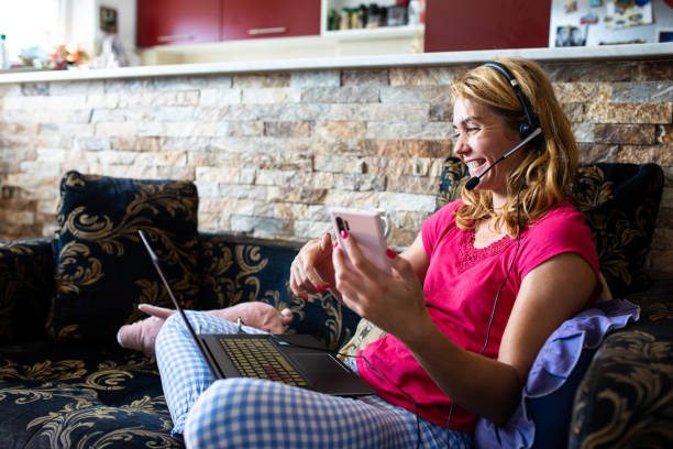 istock A woman smiling while having a conference call at home 1272837530