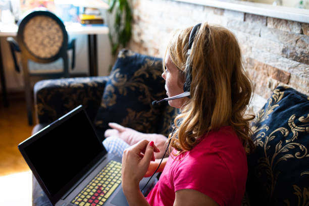 istock A young woman talking into a headset while teleworking 1272837531