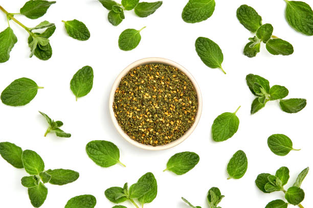 istock Middle Eastern zaatar spices with fresh zaatar leaves . Top view with copy space 1272839085