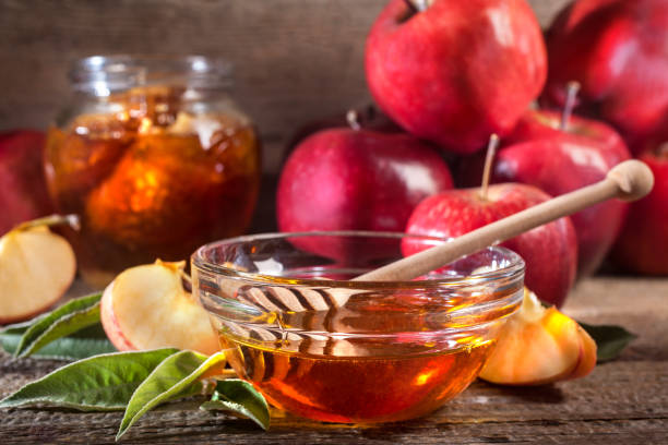 istock Apples, and honey on the rustic wooden table 1272839225