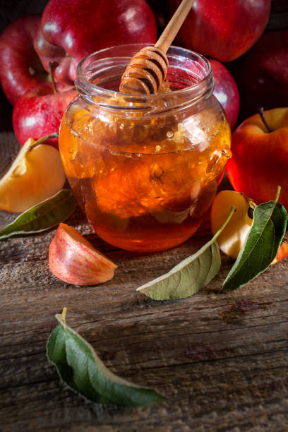 istock Apples, and honey on the rustic wooden table 1272839230