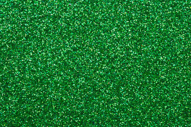 istock Shiny sequin fabric. Sparkle green texture, dark glitter background. Shimmering surface of textile. Abstract glister pattern. Brilliance backdrop. Holiday design. 1272842767