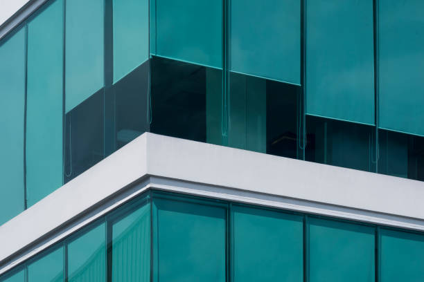 istock Green roller blinds inside of modern glass office building 1272842957