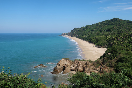 Goa, India, December 6, 2015: View of the beach Vagator in the Indian state of Goa on a sunny day. Goa is former Portugese colony.