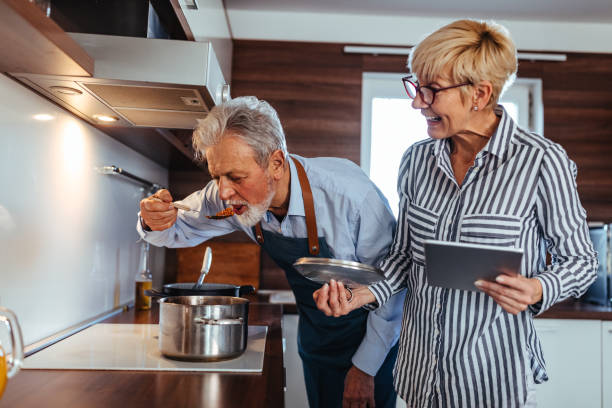 mmm, it is delicious - eating senior adult color image spaghetti imagens e fotografias de stock