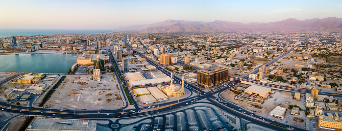 Ras al Khaimah city urban are with characteristic Midle Easter architecture aerial panoramic view during sunset at northern emirate of the United Arab Emirates