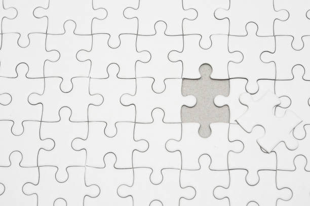 istock White jigsaw puzzle pattern background. placing last piece of jigsaw puzzle 1272851565