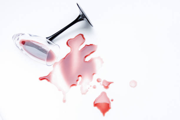 istock Broken wine glass and spilled wine on a light background. 1272851935