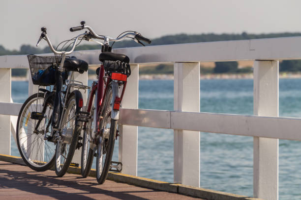 istock Two bicycles on wooden sea bridge. 1272854270