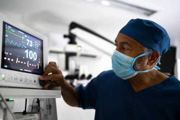 Medical ventilator being monitored by anaesthetist Medical ventilator being monitored by anaesthetist anaesthetist stock pictures, royalty-free photos & images