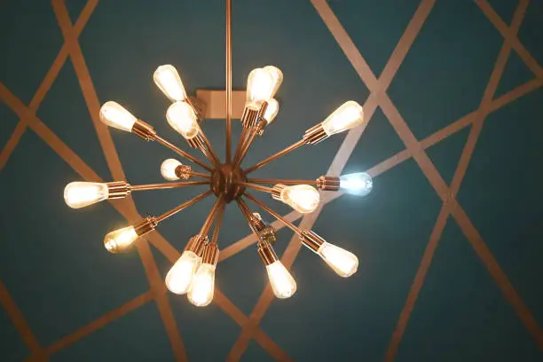 Modern chandelier with one white bulb.