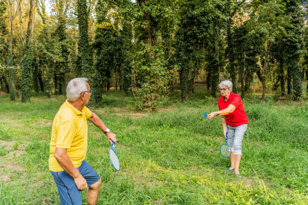 istock Happy active Senior woman playing badminton with her husband 1272856362