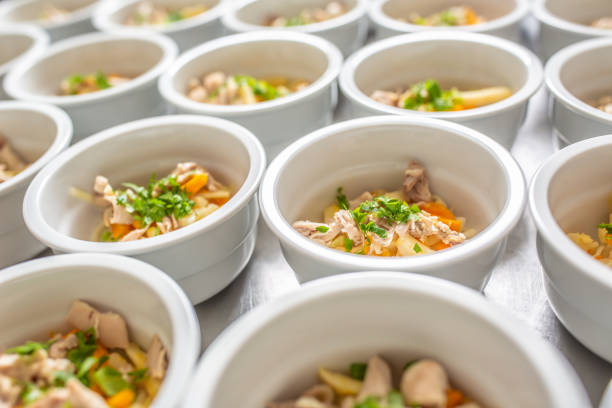 istock Bowls of chicken soup lined up for serving. 1272863646