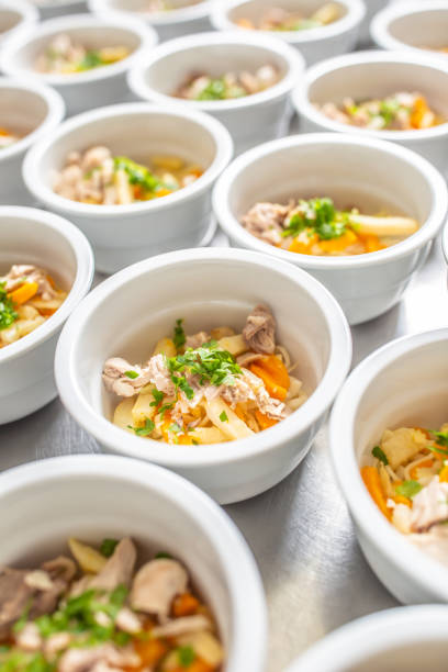 istock Bowls of chicken soup lined up for serving. 1272863658