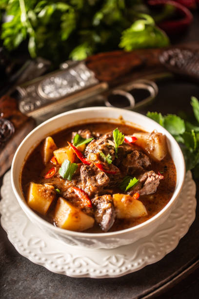 istock Deer stew in a bowl hunting weapon as a decoration. 1272863920