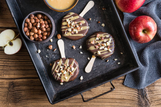 istock Apple popsicle dipped in chocolate and caramel, studded with hazelnuts 1272869464