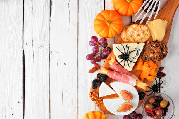 istock Halloween theme charcuterie side border against a white wood background 1272871536