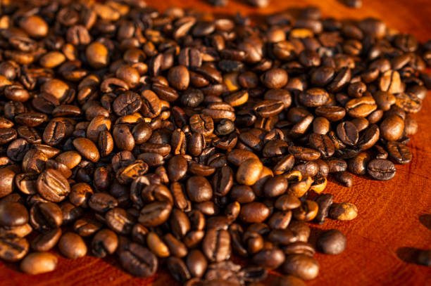 istock roasted coffee beans on wood, short depth of field 1272872661