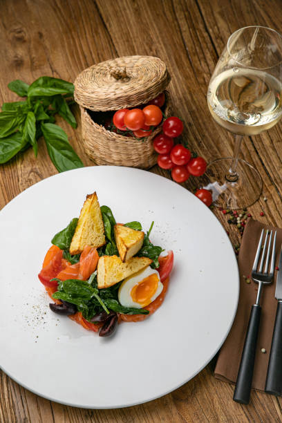 istock Salmon salad on a plate with egg, herbs, spinach and croutons 1272874828