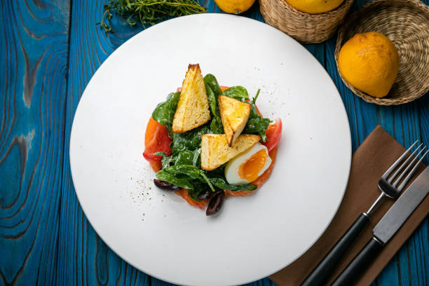 istock Salmon salad on a plate with egg, herbs, spinach and croutons 1272874849