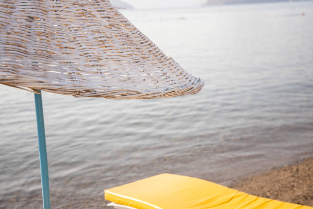 istock beach umbrella,  lounge chair and sea 1272876254