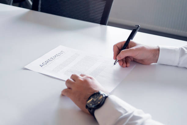 istock Close up of an unrecognizable man signing a contract 1272876863